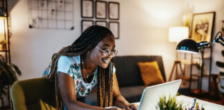 Student working in dorm room on a MacBook